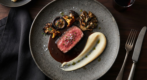 Tender A5 wagyu striploin in dark demi-glace with charred mushrooms and parsnip puree.